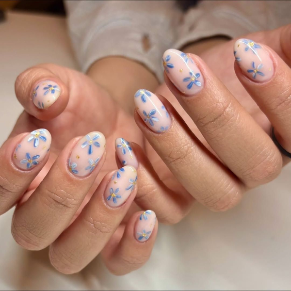 Blue flower design on milky white nails